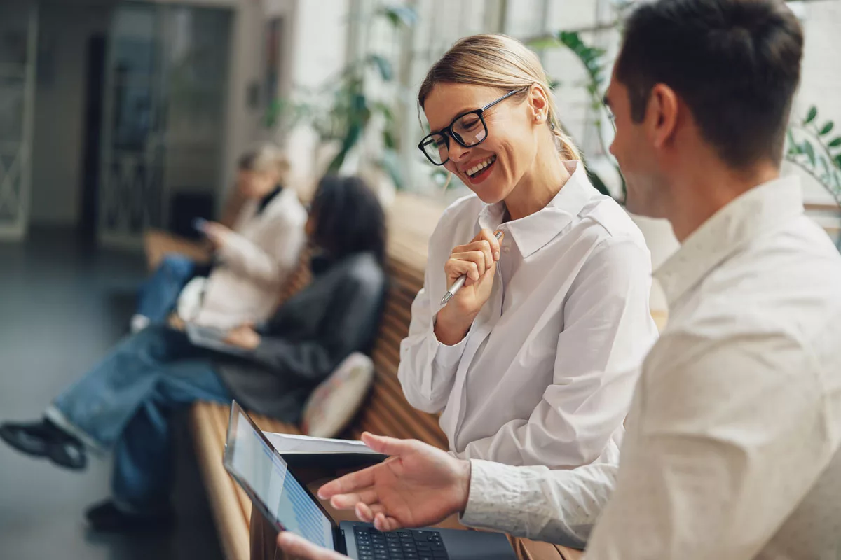woman-and-man-smiling-looking-at-computer